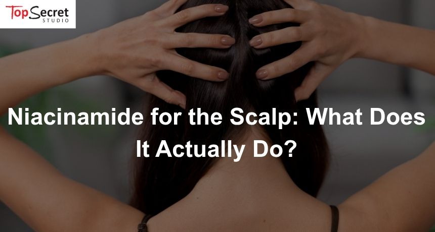 Photo of a woman massaging a scalp care product into her skin, such as niacinamide for scalp health.